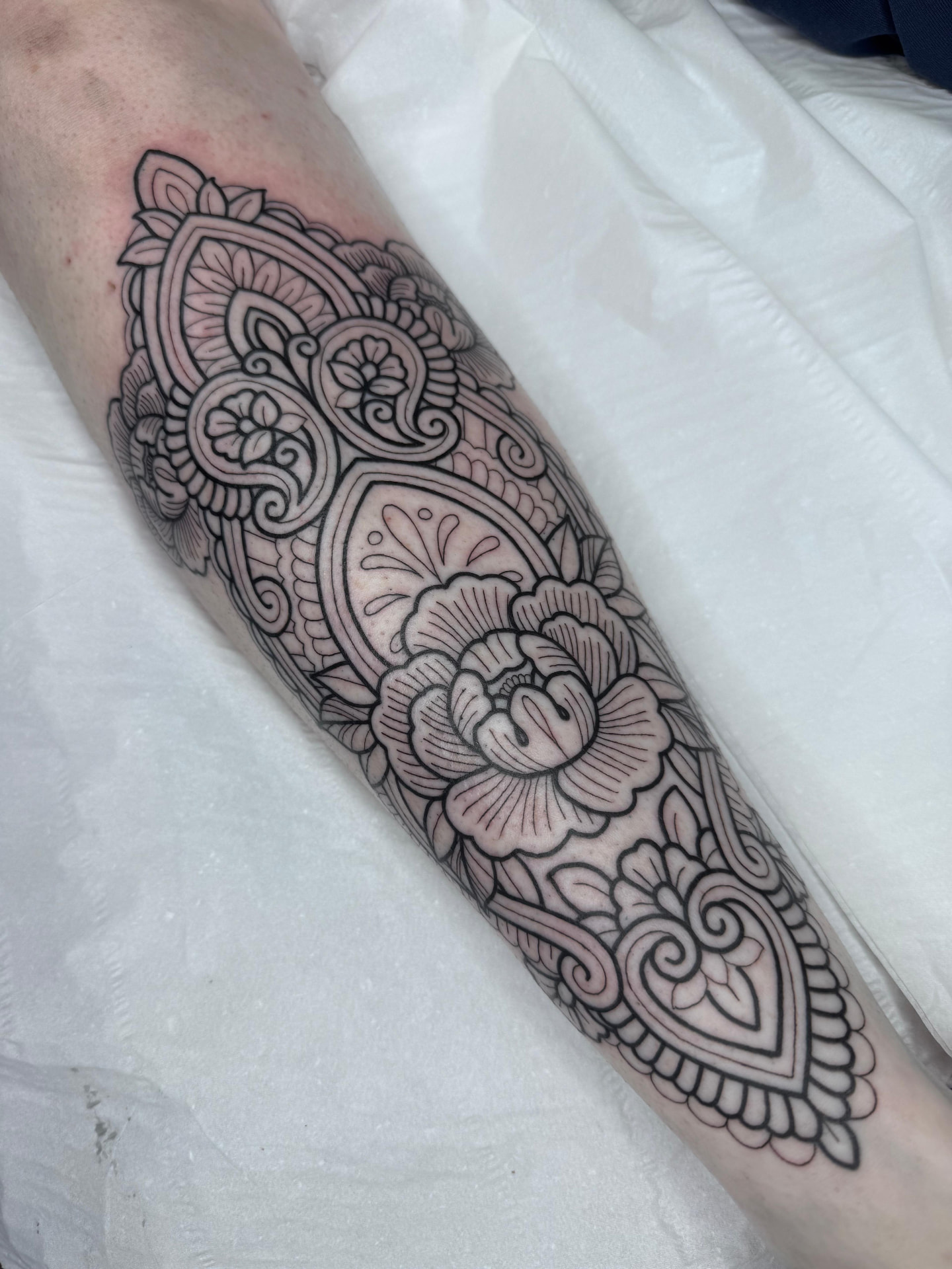 Ornamental floral mandala forearm tattoo by Greg