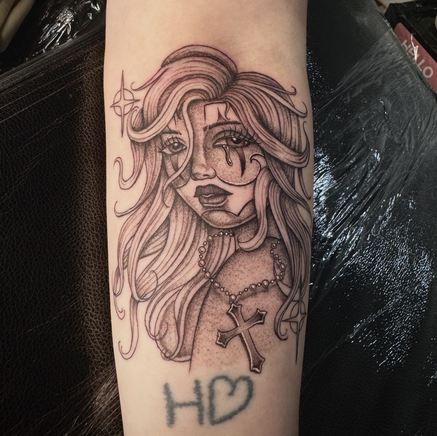 Fine-line woman portrait with rosary and cross by Liam