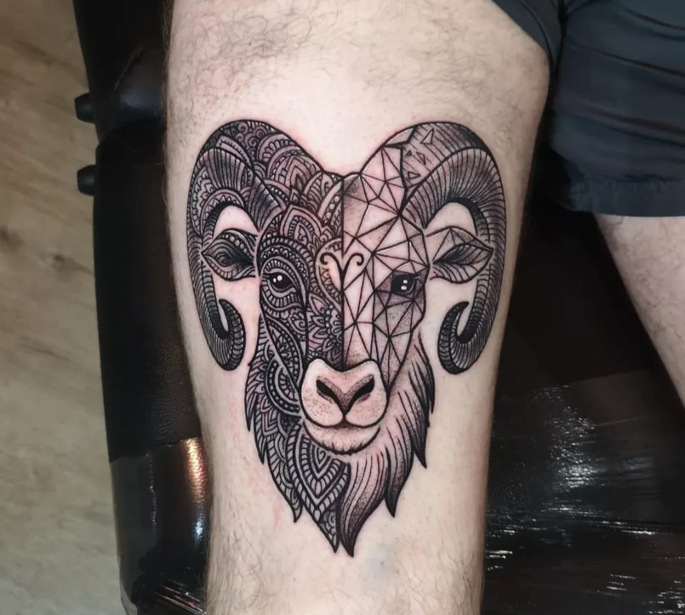 Ornamental and geometric split ram head thigh tattoo by Chris